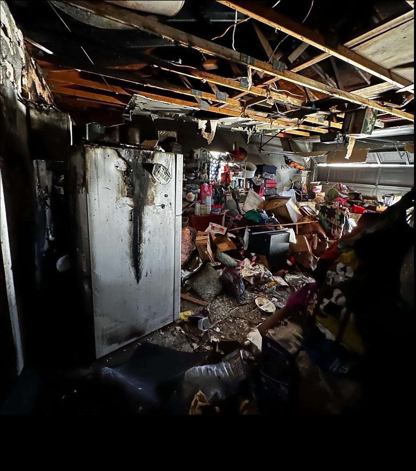 Fire-damaged room with a burned ceiling and debris