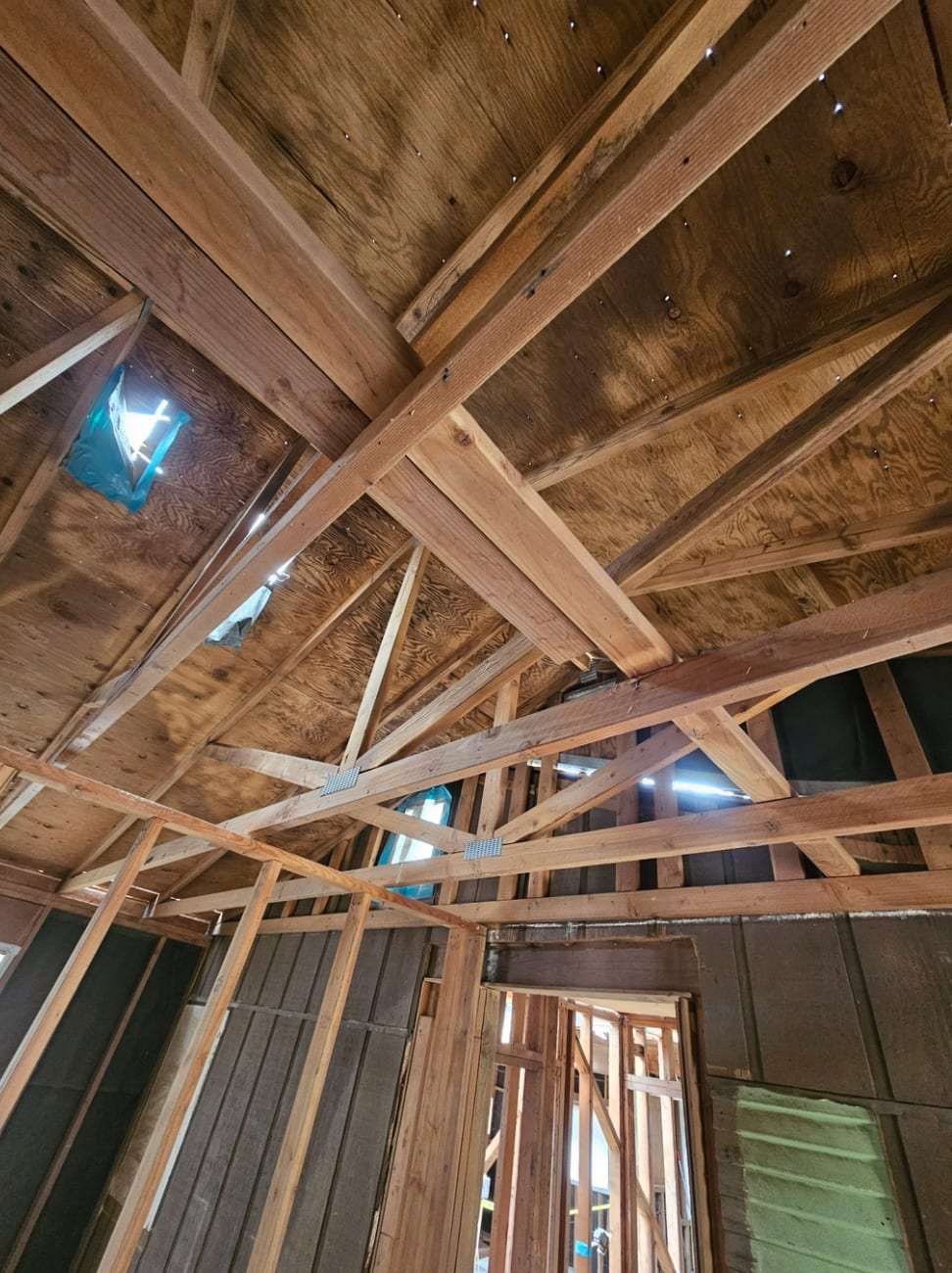Fire-darkened roof framing seen from below