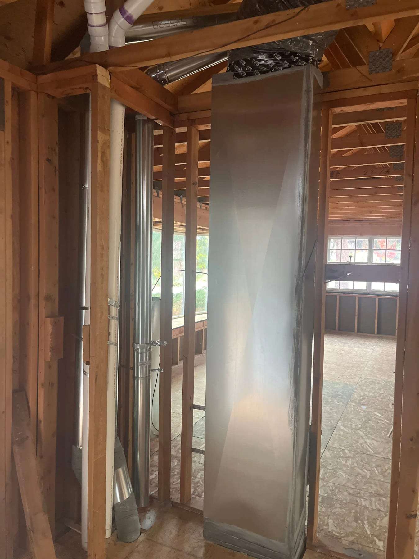 Gutted interior showing exposed framing and new ductwork